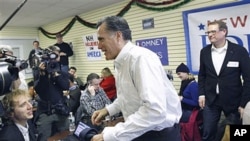 Republican presidential candidate, former Massachusetts Governor Mitt Romney, visits his campaign headquarters in Manchester, New Hampshire, January 9, 2012.