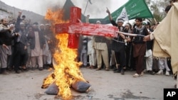 Afghans in Jalalabad burn an effigy depicting U.S. President Barack Obama following Sunday's killing of civilians in Panjwai by a U.S. soldier. 