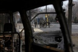 Soldiers patrol a street near the central square blocked by Kazakh troops and police in Almaty, Kazakhstan, Jan. 10, 2022.