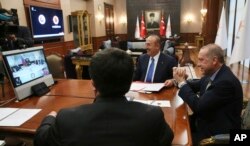Turkey's President Recep Tayyip Erdogan, right, gestures as he speaks to Venezuela's President Nicolas Maduro during a conference call, in Ankara, Turkey, May 17, 2018.