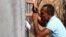 Cubans wade through a flooded street near the Malecon in Havana. Deadly Hurricane Irma battered central Cuba, knocking down power lines, uprooting trees and ripping the roofs off homes as it headed towards Florida.