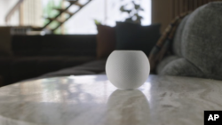 This image provided by Apple shows the new HomePod Mini that Apple unveiled Tuesday, Oct. 13, 2020. The new HomePod Mini will cost almost $100. It will integrate Apple's own music service, of course, with Pandora and Amazon's music service in “coming mont