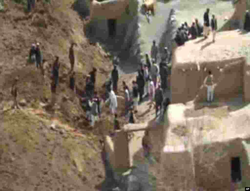 This image made from AP video shows people searching for survivors after a massive landslide landslide buried a village in Badakhshan province, northeastern Afghanistan, May 2, 2014.