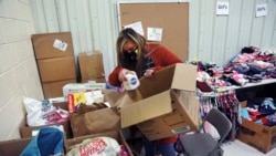 Social worker Victoria Dominguez collects supplies at Cuba High School to deliver along a rural school bus route outside Cuba, N.M., Oct. 19, 2020.