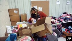 Social worker Victoria Dominguez collects supplies at Cuba High School to deliver along a rural school bus route outside Cuba, N.M., Oct. 19, 2020.