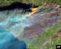 A false-color image from the European Space Agency's Sentinel-2 satellite via NASA shows a brown burn scar from the Thomas fire north of the city of Ventura, Calif., at bottom center, Dec. 7, 2017.