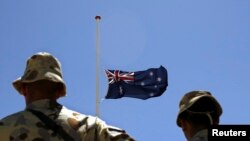 FILE - Australian troops stand at attention during a ceremony at Camp Armadillo in Afghanistan's in Helmand province, April 25, 2008. 