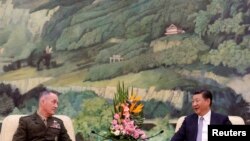 U.S. Chairman of the Joint Chiefs of Staff Gen. Joseph Dunford chats with President Xi Jinping during a meeting at the Great Hall of the People in Beijing, China, Aug. 17, 2017. 