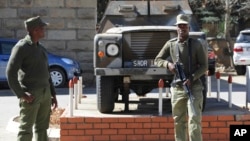 FILE - Army personnel are seen outside the military headquarters in Maseru, Lesotho.