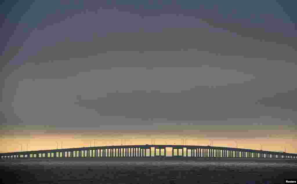 Cars cross Pensacola Bay as low clouds roll in from Tropical Storm Karen in Pensacola, Florida, as the weakening system approaches in the Gulf of Mexico.