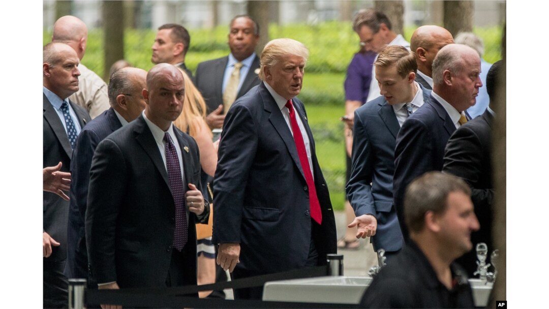 Republican presidential candidate Donald Trump, center, arrives to attend a ceremony at the National September 11 Memorial, in New York, Sept. 11, 2016, on the 15th anniversary of the Sept. 11 attacks.