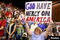 A supporter holds up a sign as Republican presidential nominee Donald Trump speaks during a campaign rally in Sarasota, Florida, U.S. Nov. 7, 2016.