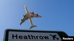FILE - An aircraft takes off from Heathrow airport in west London. 