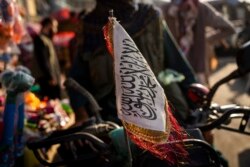 FILE - A Taliban flag is placed in the front of a motorbike in Kabul, Afghanistan, Sept. 28, 2021.