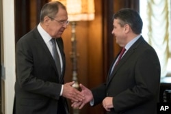 Russian Foreign Minister Sergey Lavrov, left, shakes hands with German counterpart Sigmar Gabriel in Moscow, Russia, March 9, 2017.