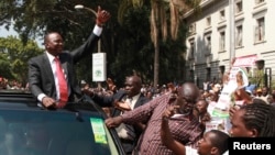 Kenya's Deputy Prime Minister Uhuru Kenyatta leaves in company of supporters after he was cleared by the Independent Electoral and Boundaries Commission to run for the presidency in the March 4 presidential elections in capital Nairobi, January 30, 2013.