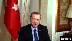 FILE - Turkish President Recep Tayyip Erdogan talks during an interview in Istanbul.