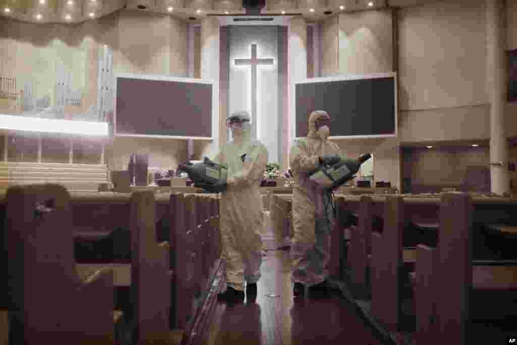 Public officials disinfect pews as a precaution against the coronavirus at the Yoido Full Gospel Church in Seoul, South Korea.