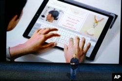 Phil Schiller, Apple's senior vice president of worldwide marketing, introduces the new iPad Pro at the Bill Graham Civic Auditorium in San Francisco, Sept. 9, 2015.