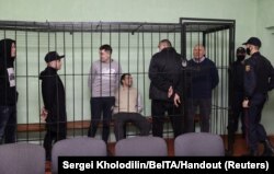 Syarhei Tsikhanouski speaks with co-defendants including Dmitry Popov, Artyom Sakov, Vladimir Tsyganovich and Igor Losik during a court hearing in Gomel (Homel), Belarus, Dec. 14, 2021.