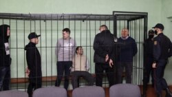 Syarhei Tsikhanouski, the husband of Belarus' opposition leader Sviatlana Tsikhanouskaya and a video blogger accused of organizing mass unrest, speaks with co-defendants including Dmitry Popov, Artyom Sakov, Vladimir Tsyganovich and Igor Losik during a c