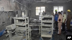 People inspect a hospital's COVID-19 ward that caught fire, in Ahmednagar, in the western Indian state of Maharashtra, Nov. 6, 2021.