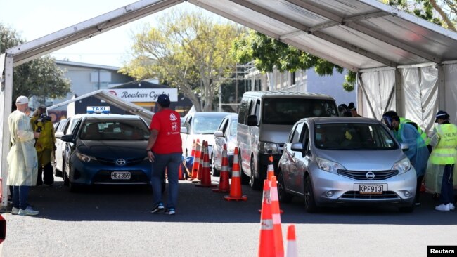 Members of the public wait in cars to be inoculated against COVID-19 during a one-day