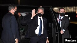 U.S. Secretary of State Antony Blinken waves as he walks to board his plane to travel to the G7 summit of foreign and development ministers in Liverpool, Britain, at Joint Base Andrews, Maryland, Dec. 9, 2021.