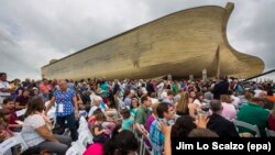 Visitors pass outside the front of a replica Noah's Ark at the Ark Encounter theme park during a media preview day, Tuesday, July 5, 2016, in Williamstown, Ky. 