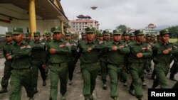 FILE - United Wa State Army (UWSA) soldiers march during a media display in Pansang, Wa territory in northeast Myanmar, Oct. 4, 2016. 