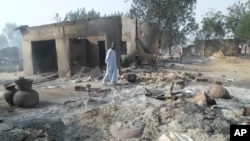 A man walks past burnt out houses following an attack by Boko Haram in Dalori village 5 kilometers (3 miles) from Maiduguri, Nigeria, Jan. 31, 2016.