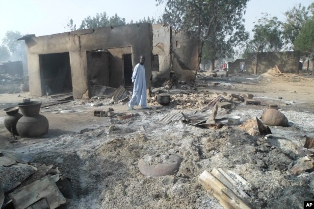 A man walks past burnt-out houses following an attack by Boko Haram in Dalori village 5 kilometers (3 miles) from Maiduguri, Nigeria, Jan. 31, 2016.