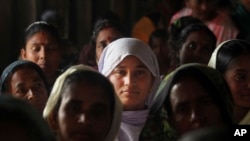 FILE - Migrant Muslim women are seen at a health mission in Baralakhaiti village, about 70 kilometers (43 miles) north of Gauhati, Assam State, India, Feb. 10, 2014.
