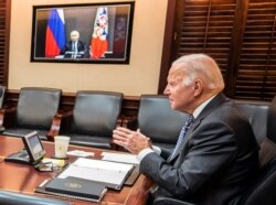 FILE - U.S. President Joe Biden holds virtual talks with Russia's President Vladimir Putin amid Western fears that Moscow plans to attack Ukraine, during a secure video call from the Situation Room at the White House, Dec. 7, 2021.
