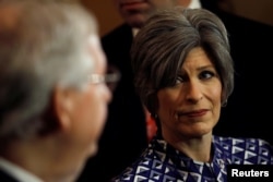 U.S. Sen. Joni Ernst, R-Iowa, looks at Senate Majority Leader Mitch McConnell of Kentucky during a news conference following leadership elections at the U.S. Capitol in Washington, Nov. 14, 2018.