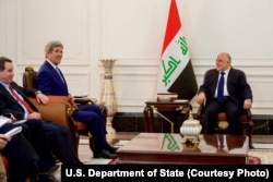 U.S. Secretary of State John Kerry, second from left, sits with Iraqi Prime Minister Haider Al-Abadi inside the prime minister's Palace in Baghdad, Iraq, April 8, 2016.