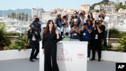 Ceremony host Monica Bellucci poses for photographers during the photo call for the film Ismael's Ghosts, at the 70th international film festival, Cannes, southern France, May 16, 2017. 
