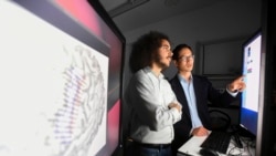 In this Friday, June 7, 2019 photo provided by the University of California, San Francisco, Dr. Edward Chang, right, and postdoctoral scholar David Moses work at UCSF's Mission Bay campus. (Noah Berger/UCSF via AP)