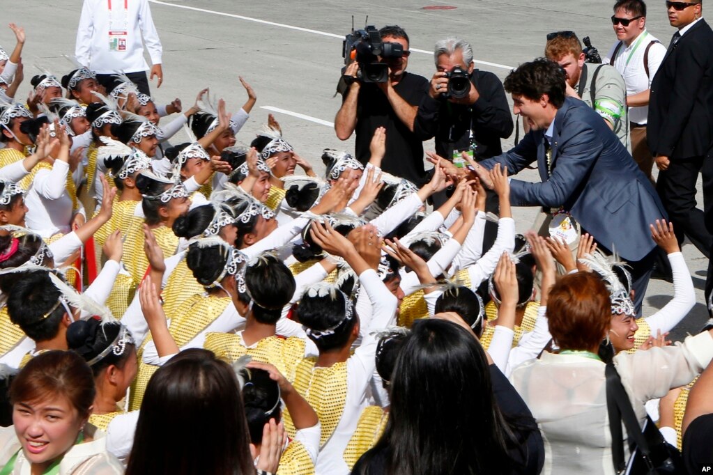  El primer ministro de Canadá, Justin Trudeau, saluda algunos artistas tras su llegada al aeropuerto internacional Clark en Clark, provincia de Pampanga, al norte de Manila, Filipinas, el 12 de noviembre de 2017.