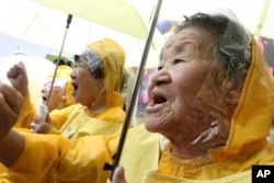 FILE - Former comfort women who served the Japanese Army as sexual slaves during World War II, at a rally before Korean Liberation Day.