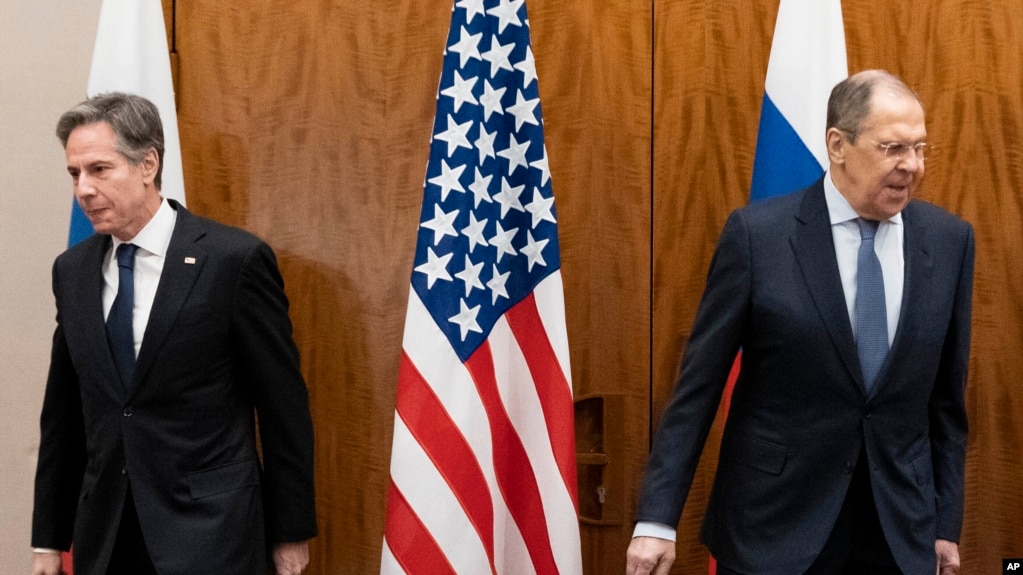 US Secretary of State Antony Blinken, left, and Russian Foreign Minister Sergey Lavrov move to their seats before their meeting, Jan. 21, 2022, in Geneva. 