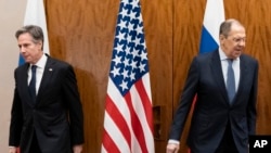 US Secretary of State Antony Blinken, left, and Russian Foreign Minister Sergey Lavrov move to their seats before their meeting, Jan. 21, 2022, in Geneva. 