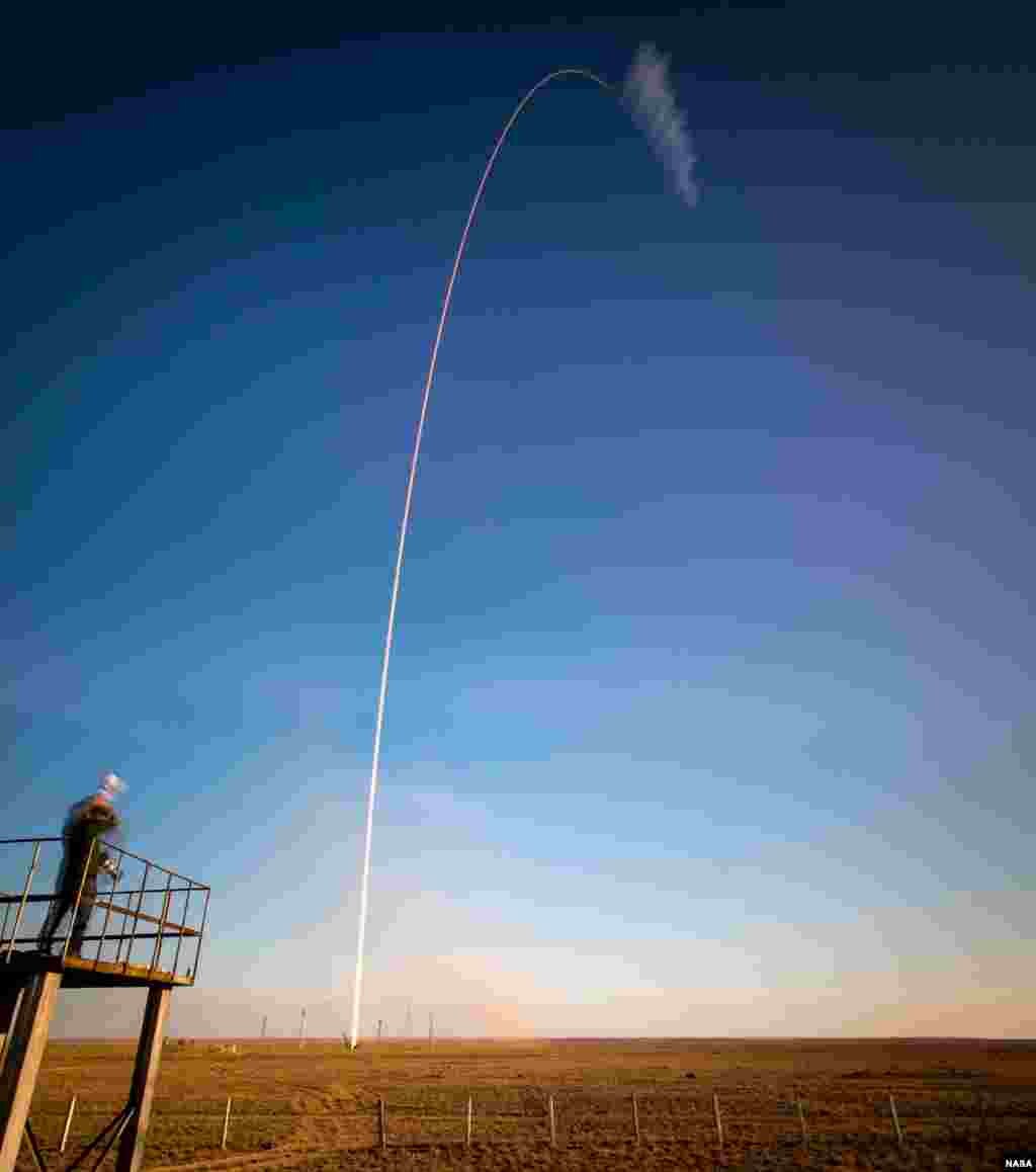 The Soyuz TMA-11M rocket is seen, in this 2 minute exposure, as it is launched with Expedition 38 Soyuz Commander Mikhail Tyurin of Roscosmos, Flight Engineer Rick Mastracchio of NASA and Flight Engineer Koichi Wakata of the Japan Aerospace Exploration Agency onboard at the Baikonur Cosmodrome in Kazakhstan.