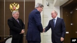 U.S. Secretary of State John Kerry, left, is welcomed by Russian President Vladimir Putin at the presidential residence of Bocharov Ruchey in Sochi, Russia, Tuesday May 12, 2015. 