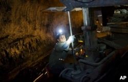 FILE – A miner works underground in the Sewell "R" coal mine in Yukon, West Virginia, Oct. 6, 2015.