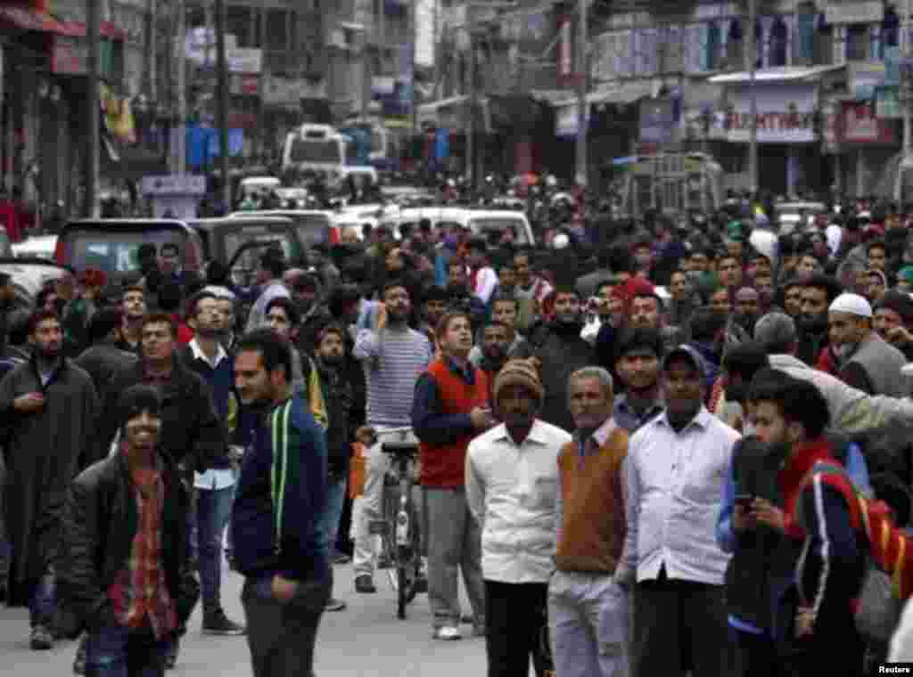 People gather outside after a strong earthquake shook northern Afghanistan and Pakistan.&nbsp;