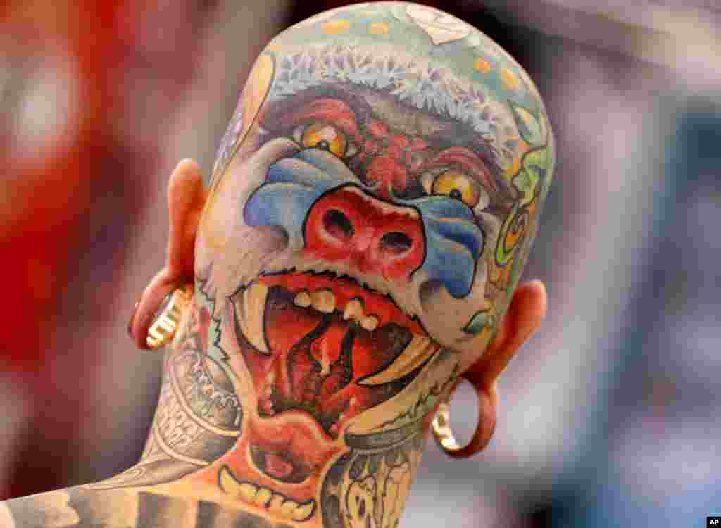 A man from the Netherlands shows his tattoos on the back of his head on the first day of the Frankfurt Tattoo Convention in Frankfurt, Germany.