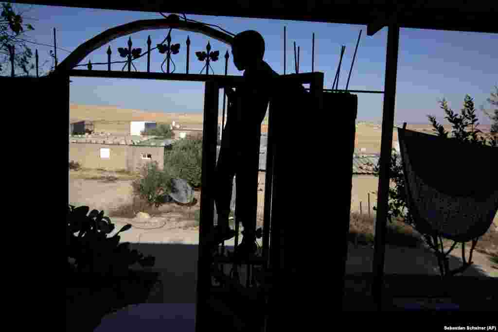 In this Wednesday, July 31, 2013 photo, a Bedouin walks through the Negev desert near the village of al-Sira, Israel.&nbsp;