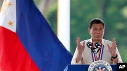 Philippine President Rodrigo Duterte gestures while speaking following a wreath-laying ceremony in observance of National Heroes Day, Aug. 29, 2016 at the Heroes Cemetery in suburban Taguig city, east of Manila.