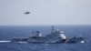 FILE - A Chinese ship and helicopter are seen during a search and rescue exercise near the Qilian Yu subgroup in the Paracel Islands, which is known in China as Xisha Islands, South China Sea, July 14, 2016.